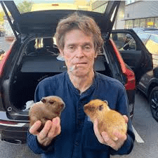 Willem Dafoe Holds Two Capybaras